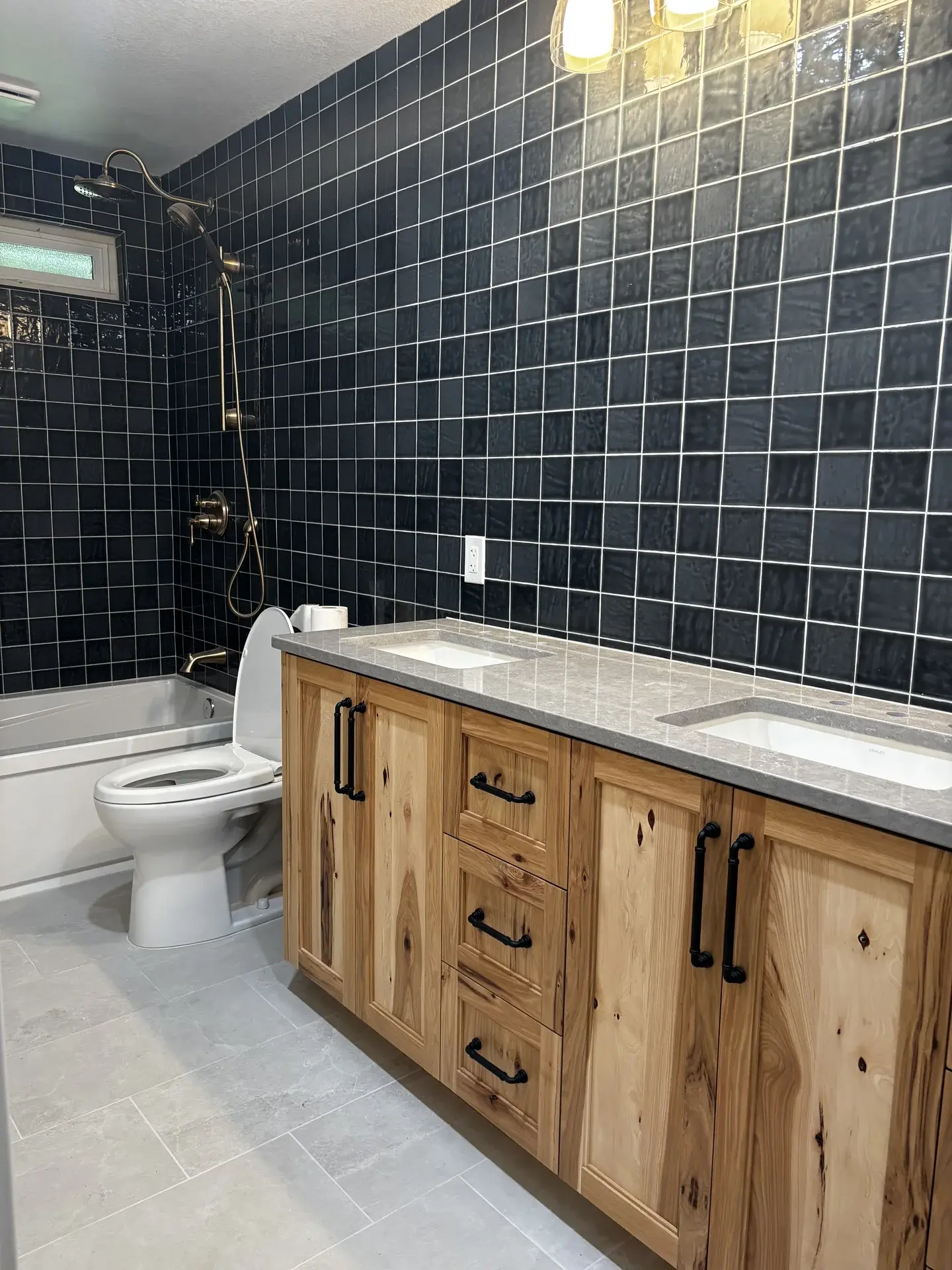 Full bathroom with blue tile walls and natural wood hickory vanity