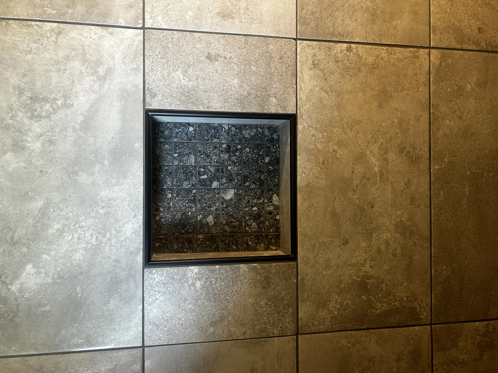 Custom shower niche with contrasting accent tile detail